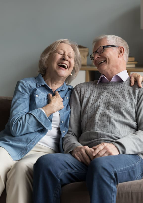 an elderly couple laughing