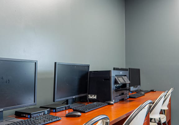 several desktop PC set up on a table